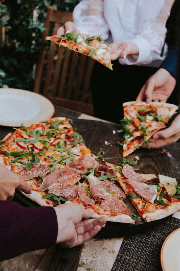 Friends eating pizza at a restaurant in Donnelly, Idaho
