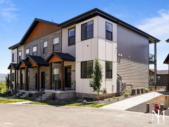 Modern multi-level townhomes at The Villages at Wolf Creek in Eden, Utah with contemporary exterior finishes and mountain-area setting.
